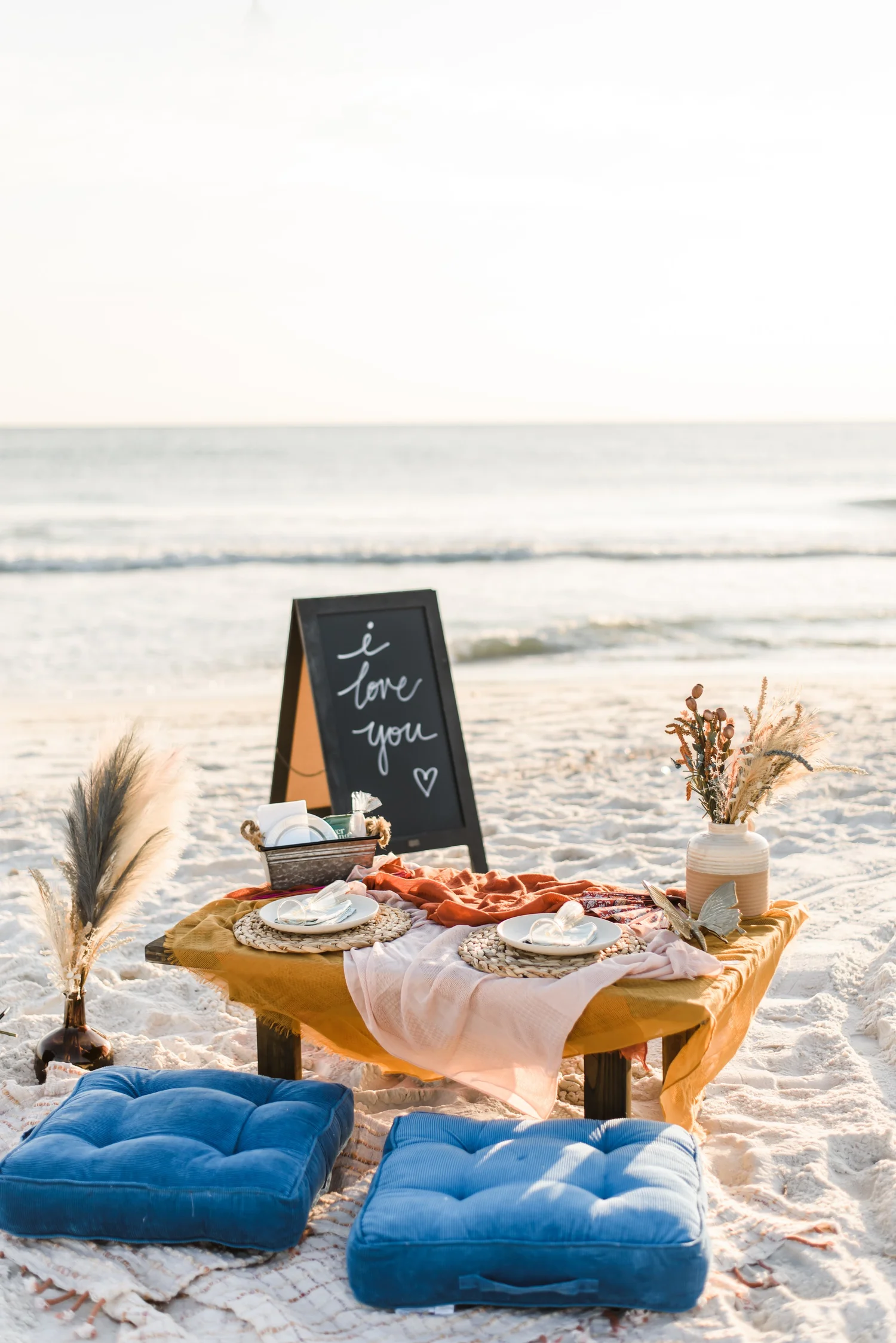 Boho beach picnic setup on the sand
